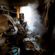 A worker for special cleaning makes uses insecticides smoke to kill flies in a garbage-filled flat in Tokyo